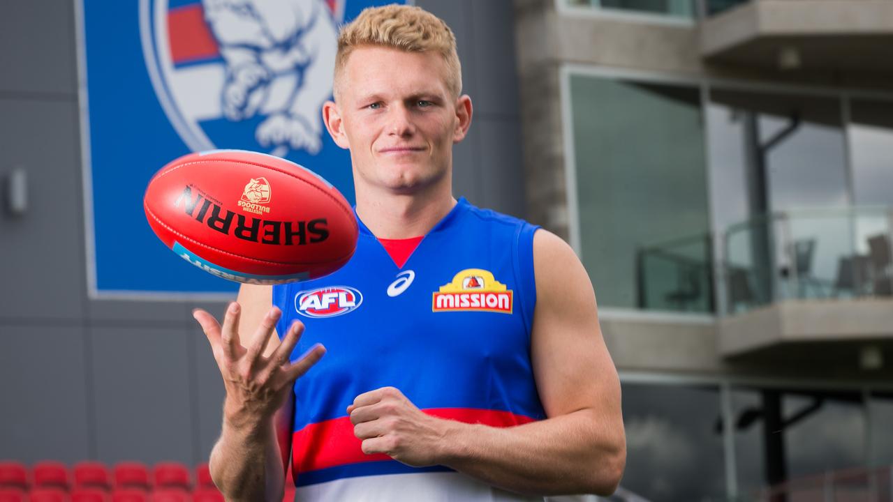 Adam Treloar tries on his new colours after being traded to Western Bulldogs.