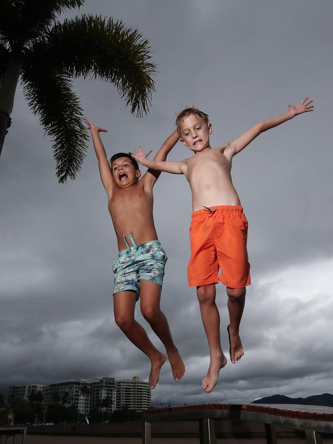 Dark grey clouds threaten to rain out Cairns' New Year's Eve fireworks on the Cairns Esplanade, but Gordonvale brothers Solomon Farreras, 10, Slade Kennedy, 8, and Luca Kennedy, 4, won't let some wet weather spoil their fun. Picture: Brendan Radke
