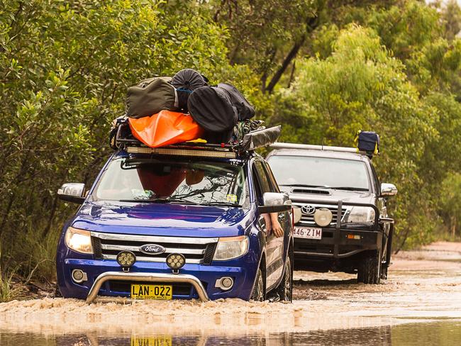 Joshua Strbik helps campers escape flooding at Kinkuna. Picture: Leon O'Neil