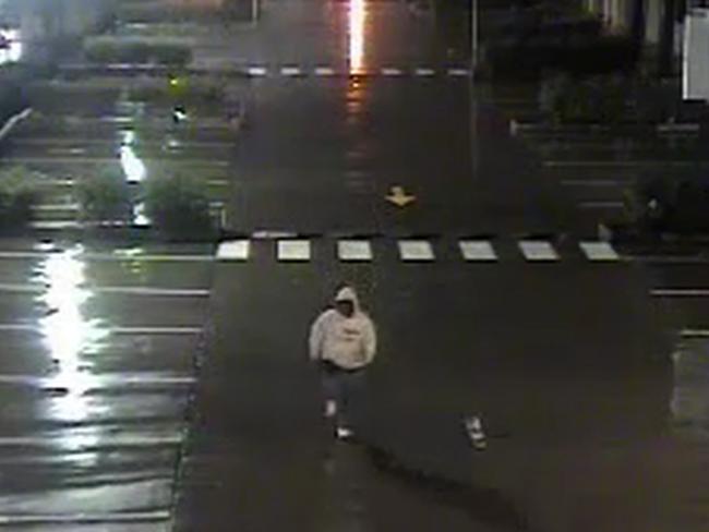 Police want to see this man in a white hood walking away from the fire. Picture: NSW Police Media