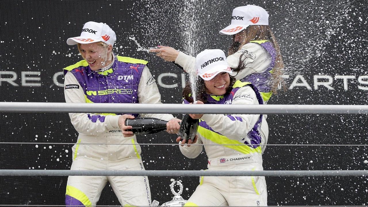 Jamie Chadwick, centre, celebrates with Alice Powell, left, and Marta Garcia after she wins the inaugural race of the new all-female W Series at Hockenheim.
