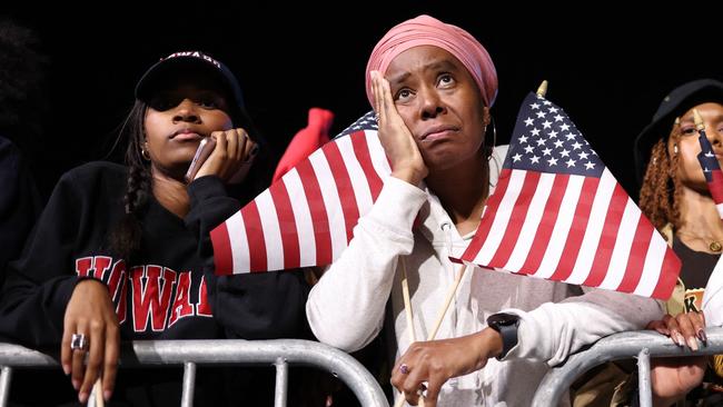 Supporters of Kamala Harris react during an election night event at Howard University in Washington, DC.