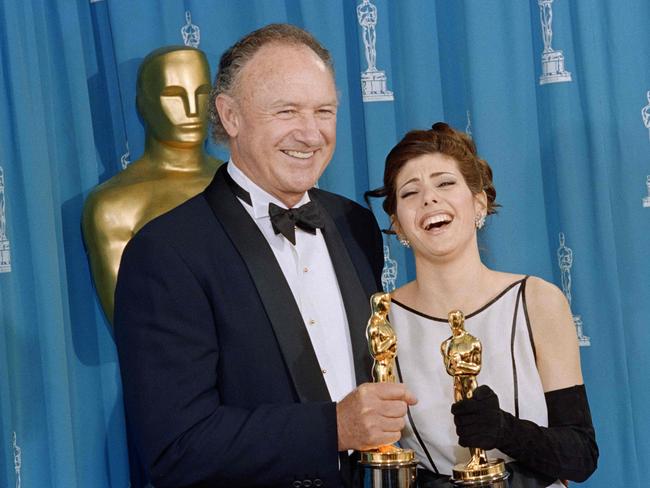 Gene Hackman with fellow Oscar winner Marisa Tomei in 1993 after his win for Unforigiven. Picture: AFP