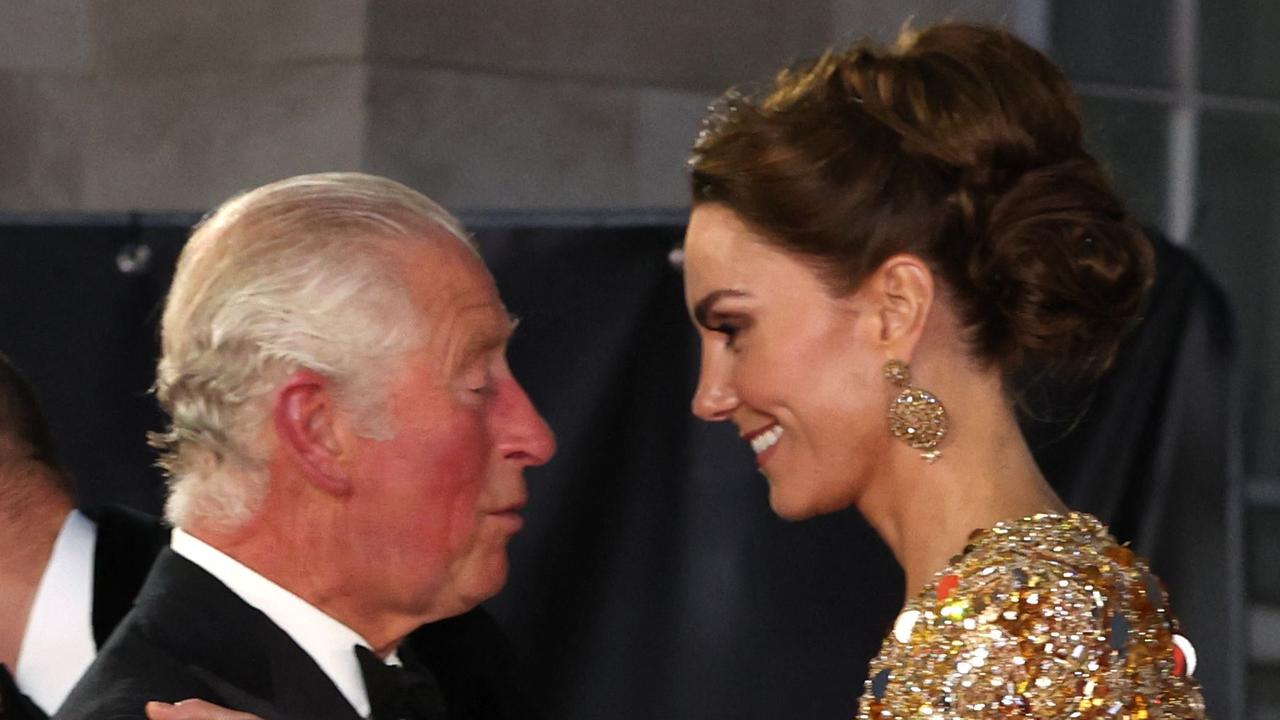 (FILES) Britain's Prince Charles, Prince of Wales (L) kisses Britain's Catherine, Duchess of Cambridge as they arrive for the World Premiere of the James Bond 007 film "No Time to Die" at the Royal Albert Hall in west London on September 28, 2021. Britain's King Charles III will attend hospital next week for a corrective procedure to treat an enlarged prostate, Buckingham Palace said on January 17, 2024. The statment was published on the same day of Kensington Palace's one announcing that Britain's Catherine, Princess of Wales is facing up to two weeks in hospital and several months' recuperation after undergoing successful abdominal surgery. (Photo by Chris Jackson / POOL / AFP)