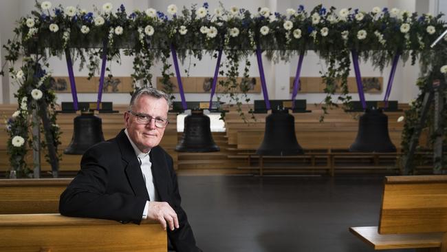 ‘More than metal’: Fr Peter Williams with the bells that were blessed ahead of their instalment. Picture: Dylan Robinson