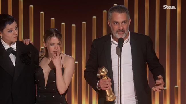 Alcock (centre) leaned on co-star Emma D’Arcy as director Miguel Sapochnik accepted the award. Picture: Stan