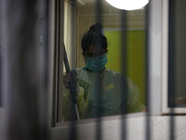 An employee cleans a room inside Dorothy Henderson Lodge today. Picture: Toby Zerna