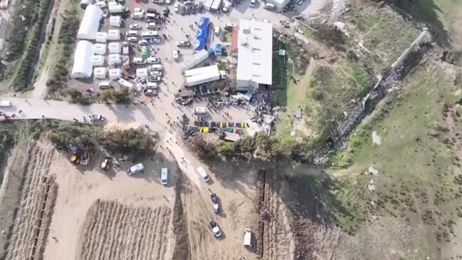 Drone shows mass grave for hundreds of quake victims