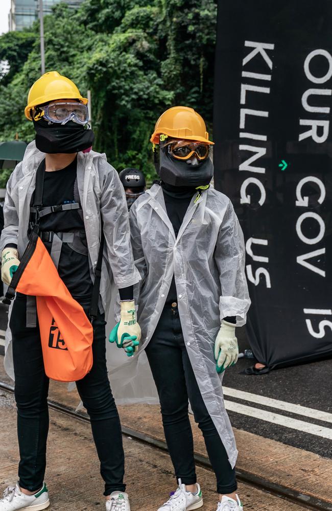 Pro-democracy protesters wearing masks despite the government ban. Picture: Getty Images