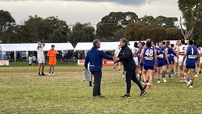 Hastings coach Gavin Artico and Mornington coach Josh Newman shake hands after the match.