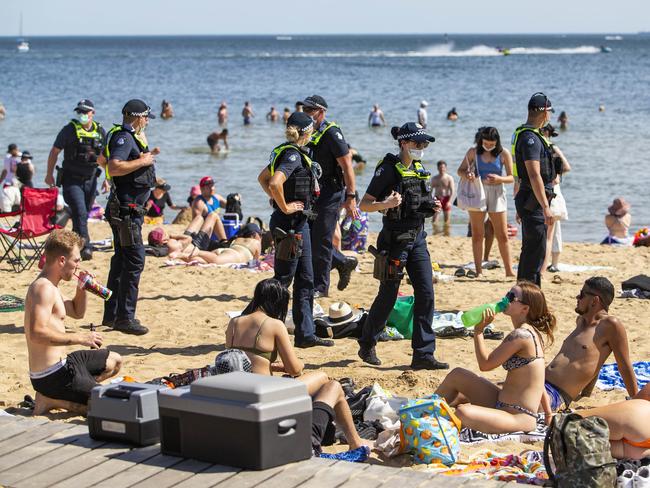 Police patrol the beach looking for open beverages. Picture: Aaron Francis