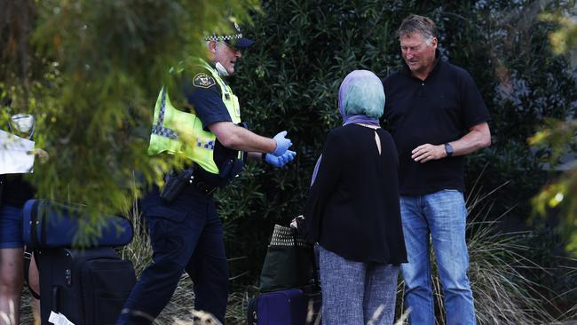 Passengers who arrived on a Jestar flight from Melbourne at Hobart Airport out the front of the Travelodge Hotel in Cambridge to start their mandatory two-week quarantine. Picture: ZAK SIMMONDS