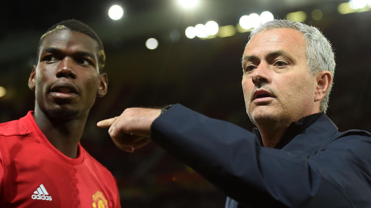 Manchester United's Portuguese manager Jose Mourinho (R) gestures to Paul Pogba