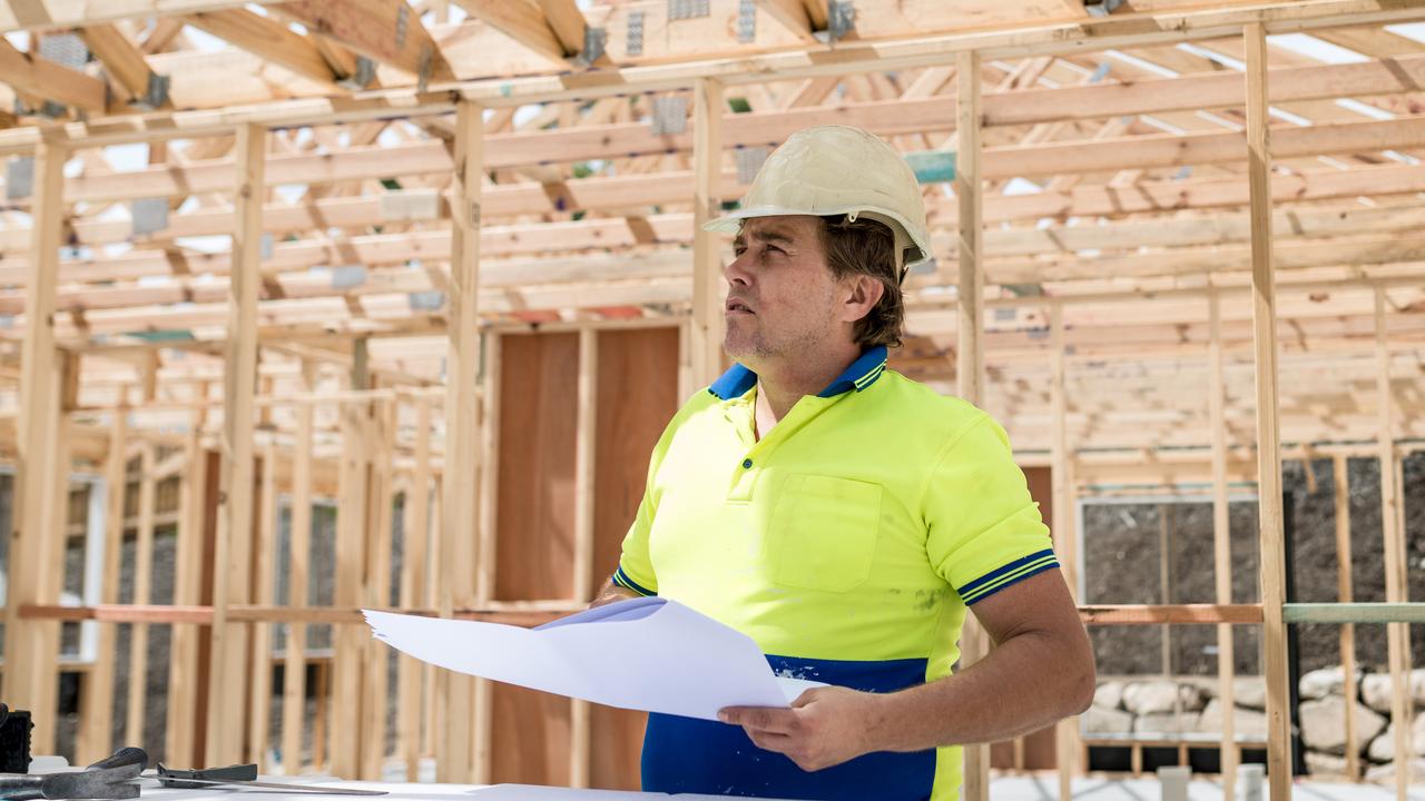 Foreman checks plans to build a house.