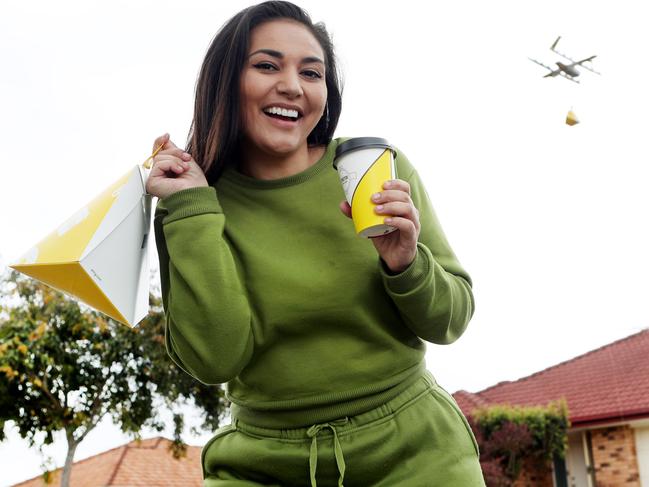 Cruze Harvey receives a drone delivery from Wings at her home in Crestmead. Picture: Tara Croser