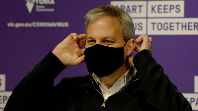 Victoria's Chief Medical Officer Brett Sutton shows how to wear a mask the right way. Picture: Andrew Henshaw