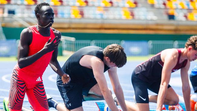 Australian sprinter Gout Gout (L) prepares for the 100m heat.