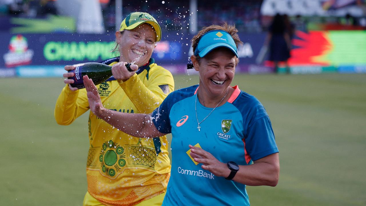 Alyssa Healy sprays coach Shelley Nitschke with champagne after the win. Picture: Marco Longari/AFP