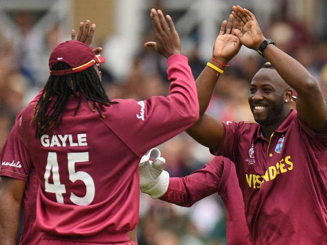 West Indies' Andre Russell (R) celebrates with West Indies' Chris Gayle (L) after taking the wicket of Pakistan's Fakhar Zaman for 22 runs during the 2019 Cricket World Cup group stage match between West Indies and Pakistan at Trent Bridge in Nottingham, central England, on May 31, 2019. (Photo by Oli SCARFF / AFP) / RESTRICTED TO EDITORIAL USE