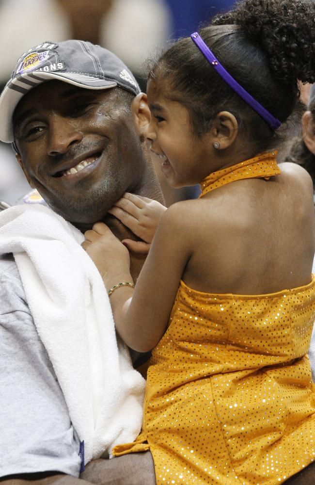 Los Angeles Lakers' Kobe Bryant holds his daughter, Gianna, after defeating the Orlando Magic 99-86 in Game 5 to win the NBA basketball finals in Orlando, Florida in 2009. Picture: AP