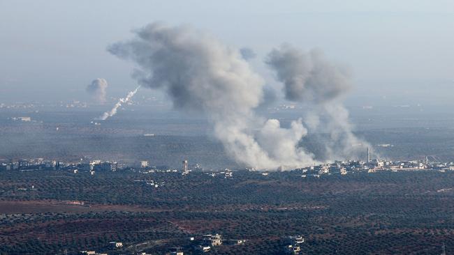 Smoke billows from the site of clashes and mutual shelling between Syrian opposition factions and regime forces on the front lines on the outskirts of the city of Saraqib. Picture: Omar Haj Kadour/AFP