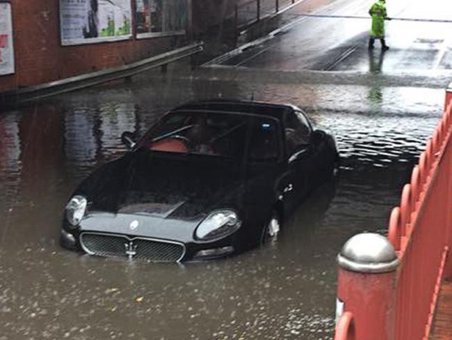 A supplied images obtained from Facebook on Saturday, December 2, 2017, of A Maserati that was flooded after the driver attempted to navigate a flooded underpass at Victoria Street in Seddon, Melbourne on Saturday. About 100mm of rain has been forecast for Melbourne between Friday and Sunday, while parts of Victoria are tipped to receive between 200mm and 300mm over the same period. (AAP Image/Supplied/Sarah Schubert) NO ARCHIVING