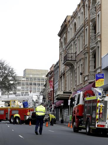 The Tasmania Fire Service inspects the damage to the roof of Hadleys Hotel.