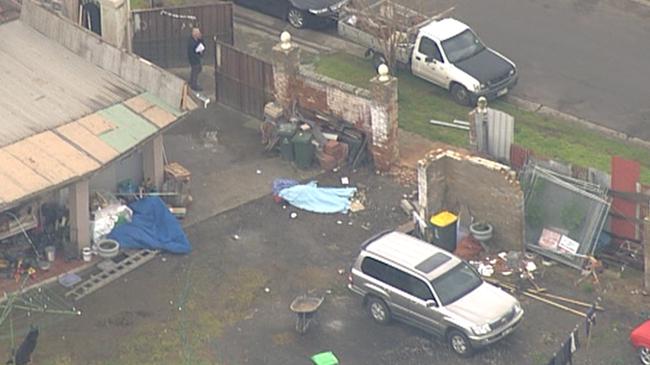 Macchour Chaouk lies dead beneath a sheet in his Brooklyn back yard. Picture: Nine News