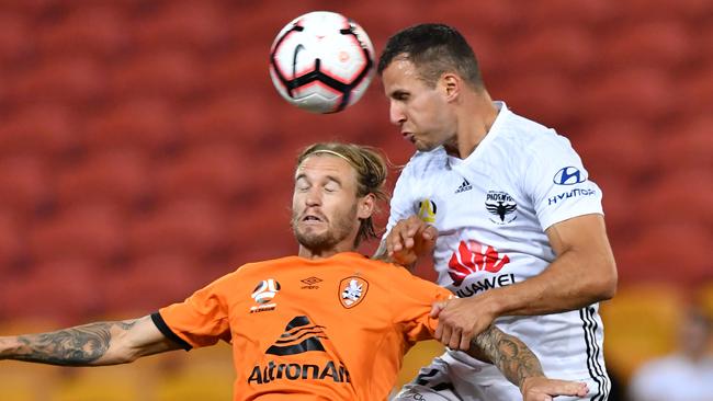 Wellington defender Steven Taylor rises high to score against the Roar on Friday night. Picture: AAP 