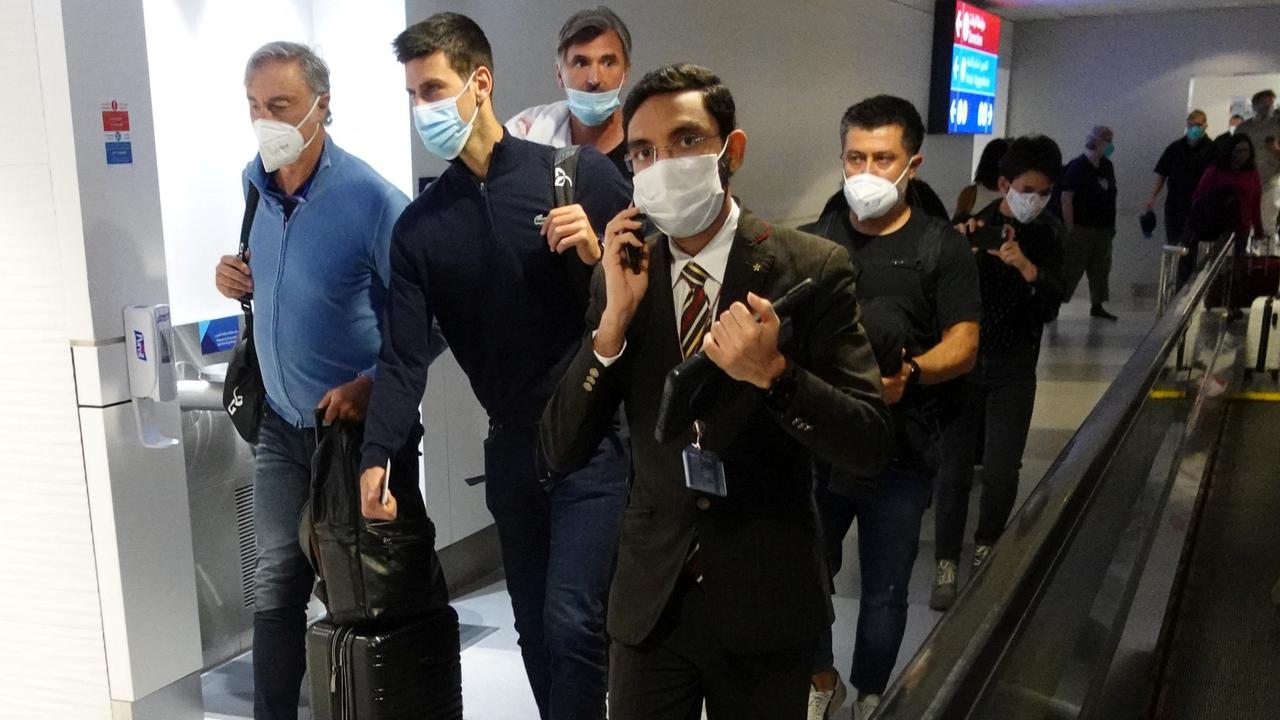 Serbian tennis player Novak Djokovic walks with his team after landing at Dubai Airport Picture: Reuters