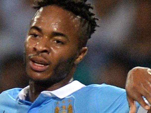 Manchester City's David Silva (L) and Raheem Sterling celebrate after Sterling scored a goal during a friendly football match against Vietnam's national team at My Dinh stadium in Hanoi on July 27, 2015. Manchester City won 8-1. AFP PHOTO / HOANG DINH NAM