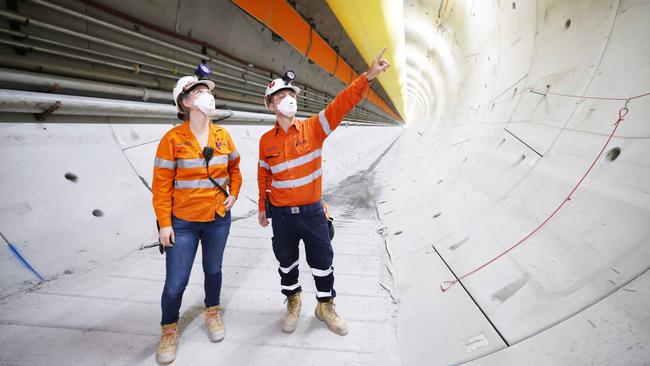 Cross River Rail workers Alena Conrads and Francesco Anghetti inspect the concrete rings. Picture: Peter Wallis