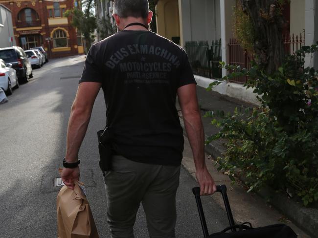 A detective collects evidence following strike force raids in May. Picture: NSW Police