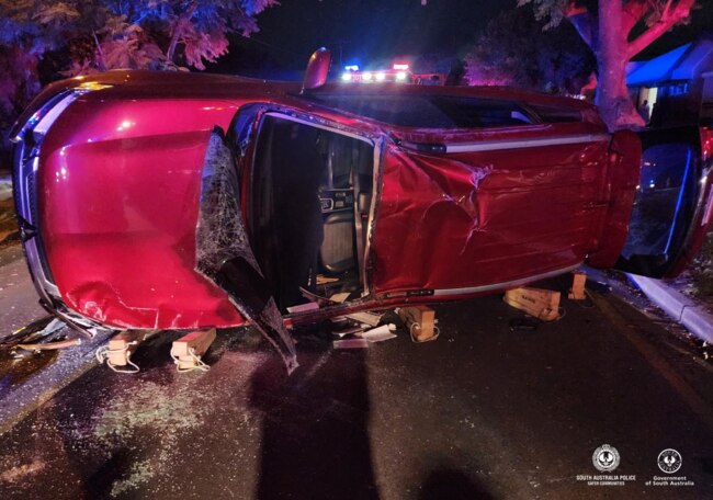 A Mitsubishi station wagon hit a parked ute on Young Street, Enfield just before 7pm on Tuesday 21 May and rolled. Pictures: SAPOL.