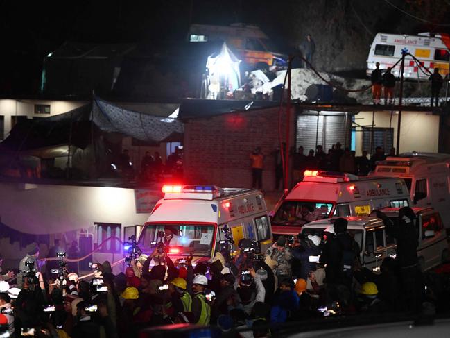 Ambulances carrying rescued workers leave the tunnel site after emergency and rescue teams safely brought out all trapped workers. Picture: AFP