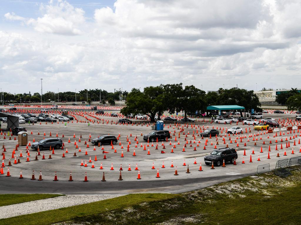 People line up in cars to receive their COVID-19 vaccine at Hard Rock Stadium in Miami. Picture: Chandan Khanna/AFP