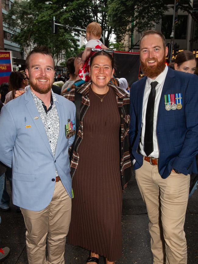 Thousands of people have braved the rain to gather in Brisbane for Anzac Day services. Picture: Grace Kessels