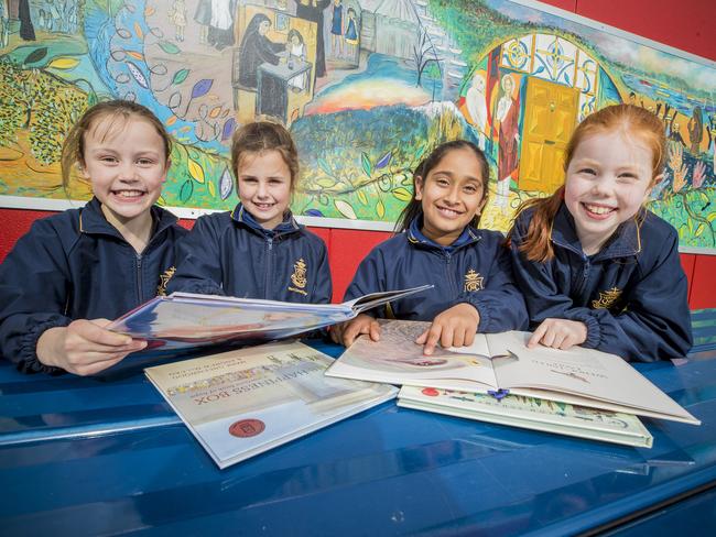 Mt Carmel College students, Jemima Geappen, Georgie Costelloe, Taqdeer Kaur and Isobel Denby enjoying reading. NAPLAN Grade 3 reading and writing results are good for Tasmania.. Picture: RICHARD JUPE