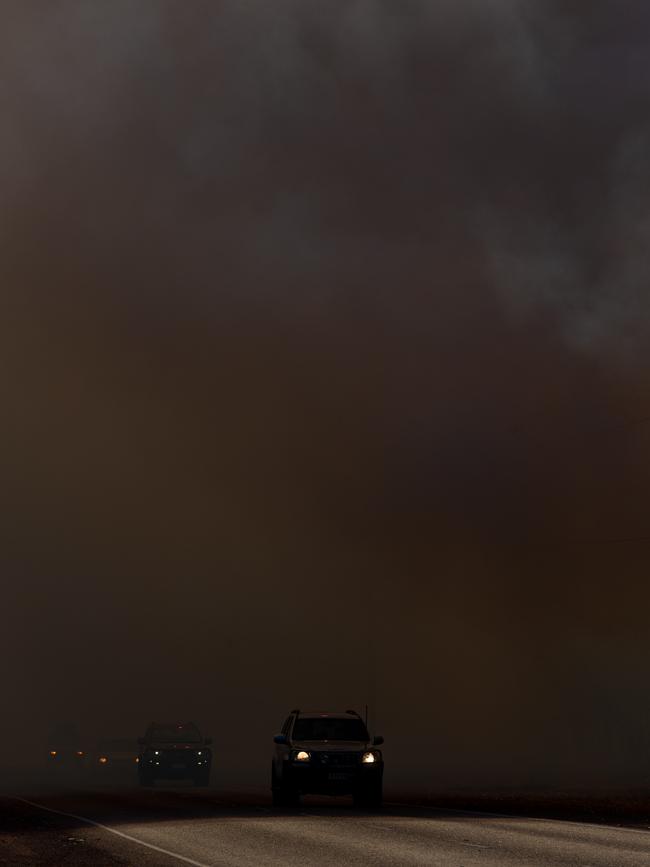 Smoke from the wild bushfires turned day to night as firefighter fought to save properties. The Arnhem Highway was closed as condition made driving hazardous. Picture: Che Chorley