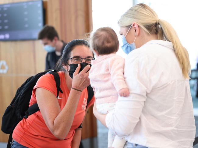 Mary Clarke looks at her granddaughter Arabella, held by her mum Danielle Brides, at Adelaide Airport. Picture: NCA NewsWire / David Mariuz