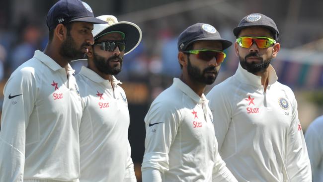 Virt Kohli (R) and teammates walks off the field in the Test against Bangladesh.