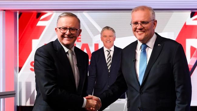 Australian Prime Minister Scott Morrison (right) and Australian Opposition Leader Anthony Albanese shake hands during the third leaders' debate at Seven Network Studios (AAP Image/Lukas Coch)