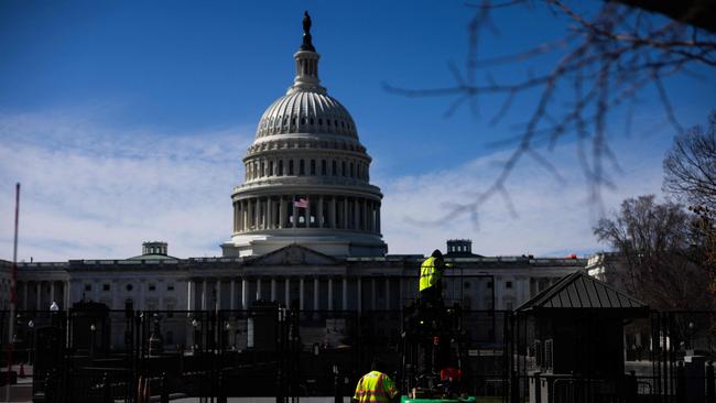 Workers put up security fencing at the US Capitol in Washington, DC on March 2, 2025, in advance of President Donald Trump's address to a joint session of Congress. Picture: AFP