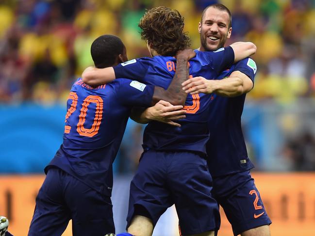 BRASILIA, BRAZIL - JULY 12: Daley Blind of the Netherlands (C) celebrates scoring his team's second goal with Georginio Wijnaldum (L) and Ron Vlaar during the 2014 FIFA World Cup Brazil Third Place Playoff match between Brazil and the Netherlands at Estadio Nacional on July 12, 2014 in Brasilia, Brazil. (Photo by Jamie McDonald/Getty Images)