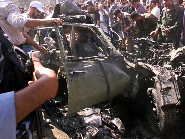 Palestinians inspect the wreckage of Hamas bomb expert, Mohammed Deif's car, which exploded in Gaza City, after it was fired at by Israeli helicopters missiles in 2002. Picture: AP Photo/Adel Hana