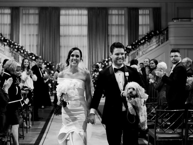 Stella the Cavoodle wore the same cream roses as her mum, Sarah Castellas who married Sean Gavin last weekend in Melbourne. Picture: Jenna Fahey-White