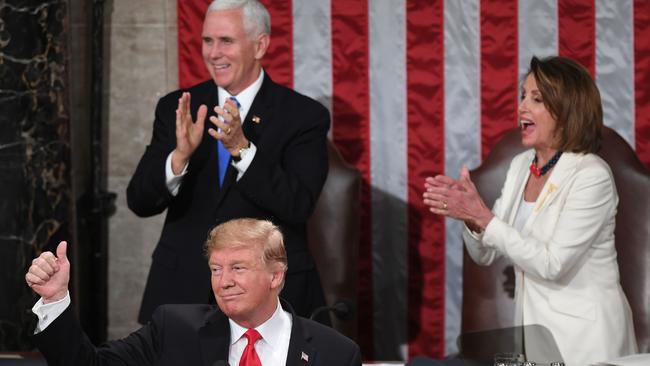 Nancy Pelosi joins applause as Donald Trump says there are more women in work and in Congress. Picture: AFP.