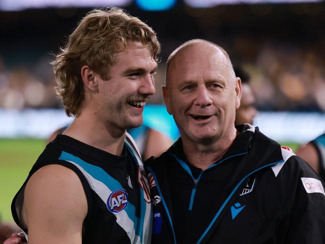 ADELAIDE, AUSTRALIA - SEPTEMBER 13: Jason Horne-Francis and Ken Hinkley of the Power celebrate their win during the 2024 AFL Second Semi Final match between the Port Adelaide Power and the Hawthorn Hawks at Adelaide Oval on September 13, 2024 in Adelaide, Australia. (Photo by James Elsby/AFL Photos via Getty Images)