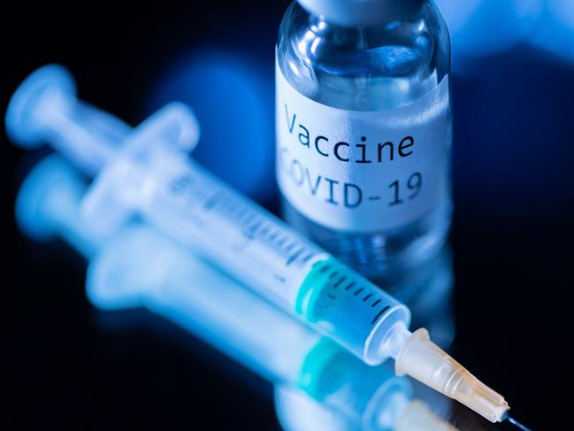 TOPSHOT - This picture taken on November 17, 2020 shows a syringe and a bottle reading "Vaccine Covid-19". - According to the World Health Organization, some 42 "candidate vaccines" against the novel coronavirus Covid-19 are undergoing clinical trials on November 17, 2020. (Photo by JOEL SAGET / AFP)