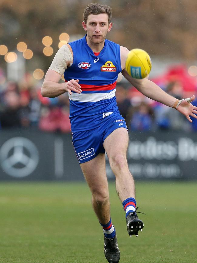 Fletcher Roberts gets a kick away during one of his two AFL matches last season. Picture: Michael Klein